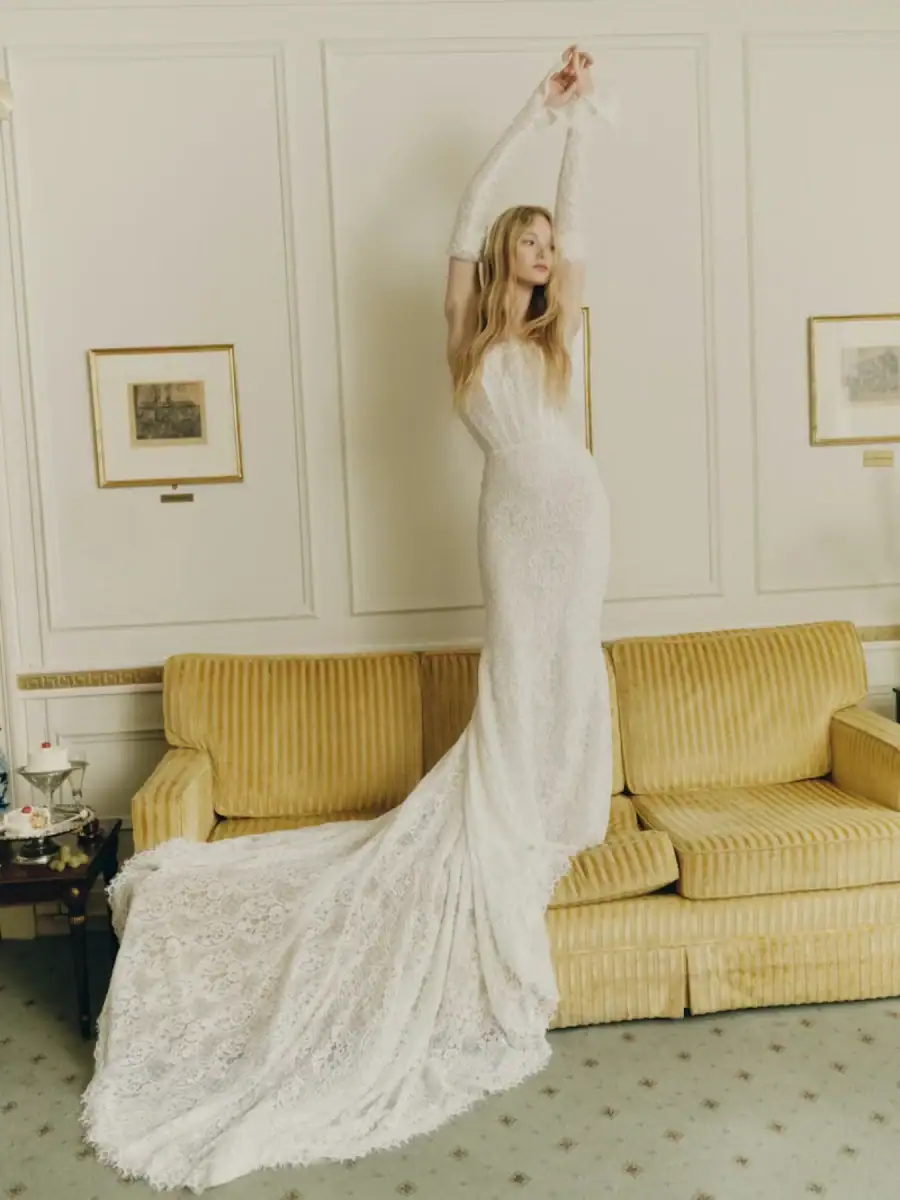 Lace fit and flare wedding dress with visible boning and detached long sleeves