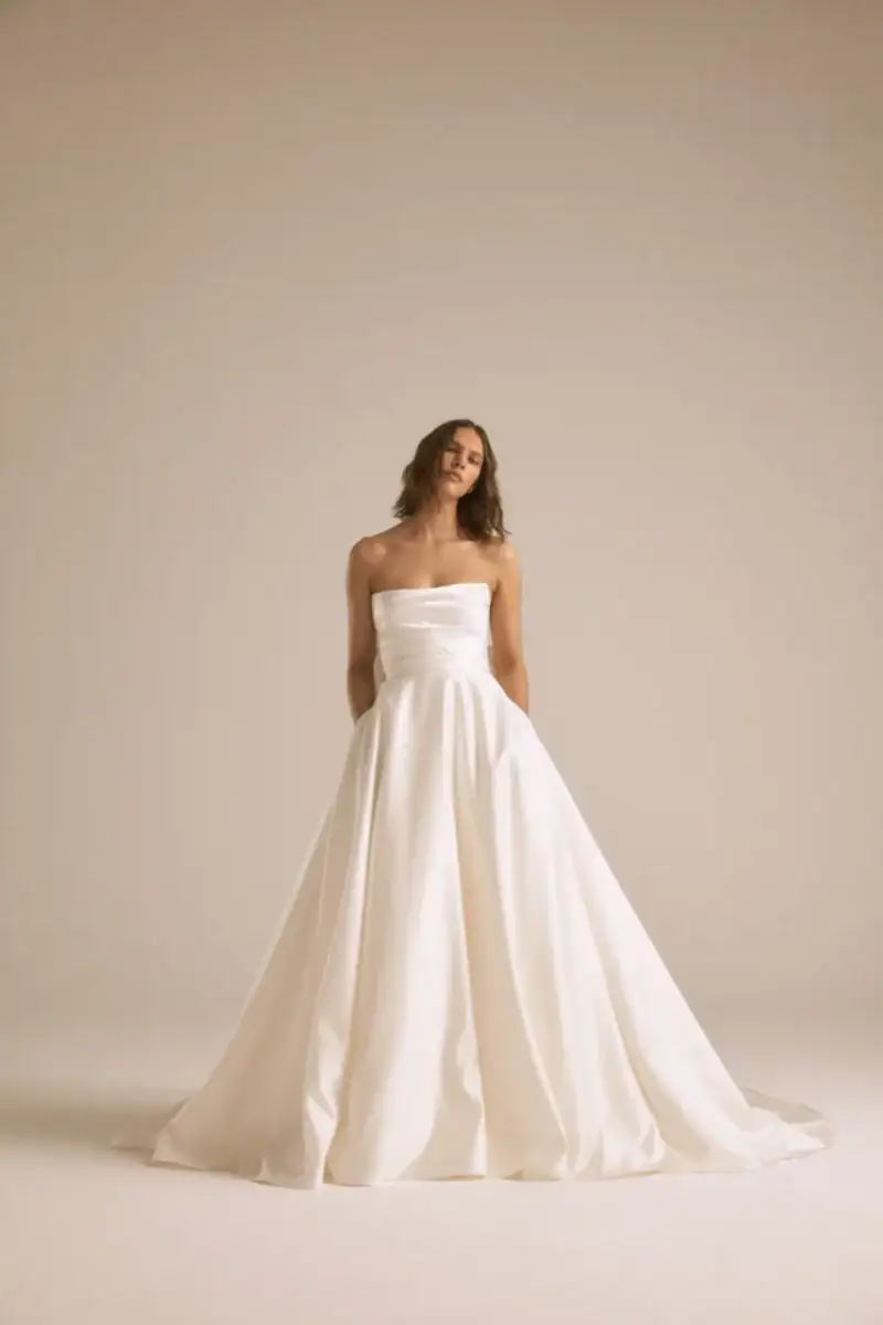 full front of amsale atlas ivory mikado ball gown wedding dress with a strapless straight neckline and pleated skirt
