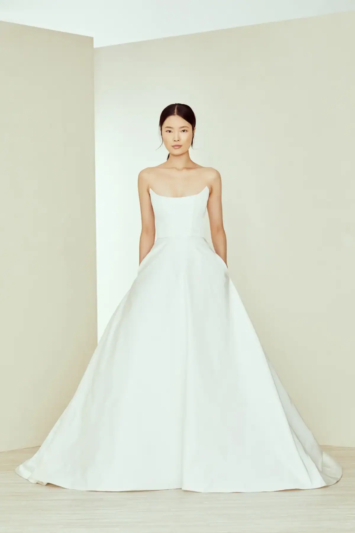 full front of amsale charleston silky ball gown wedding dress with a strapless scoop neckline and pockets in the skirt
