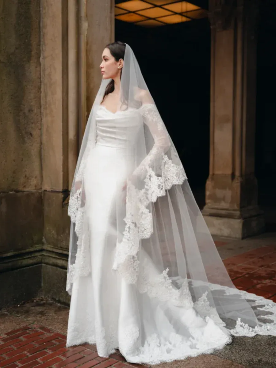 full front of bliss by monique lhuillier bl26104 silky fitted wedding dress featuring a matching veil trimmed with lace