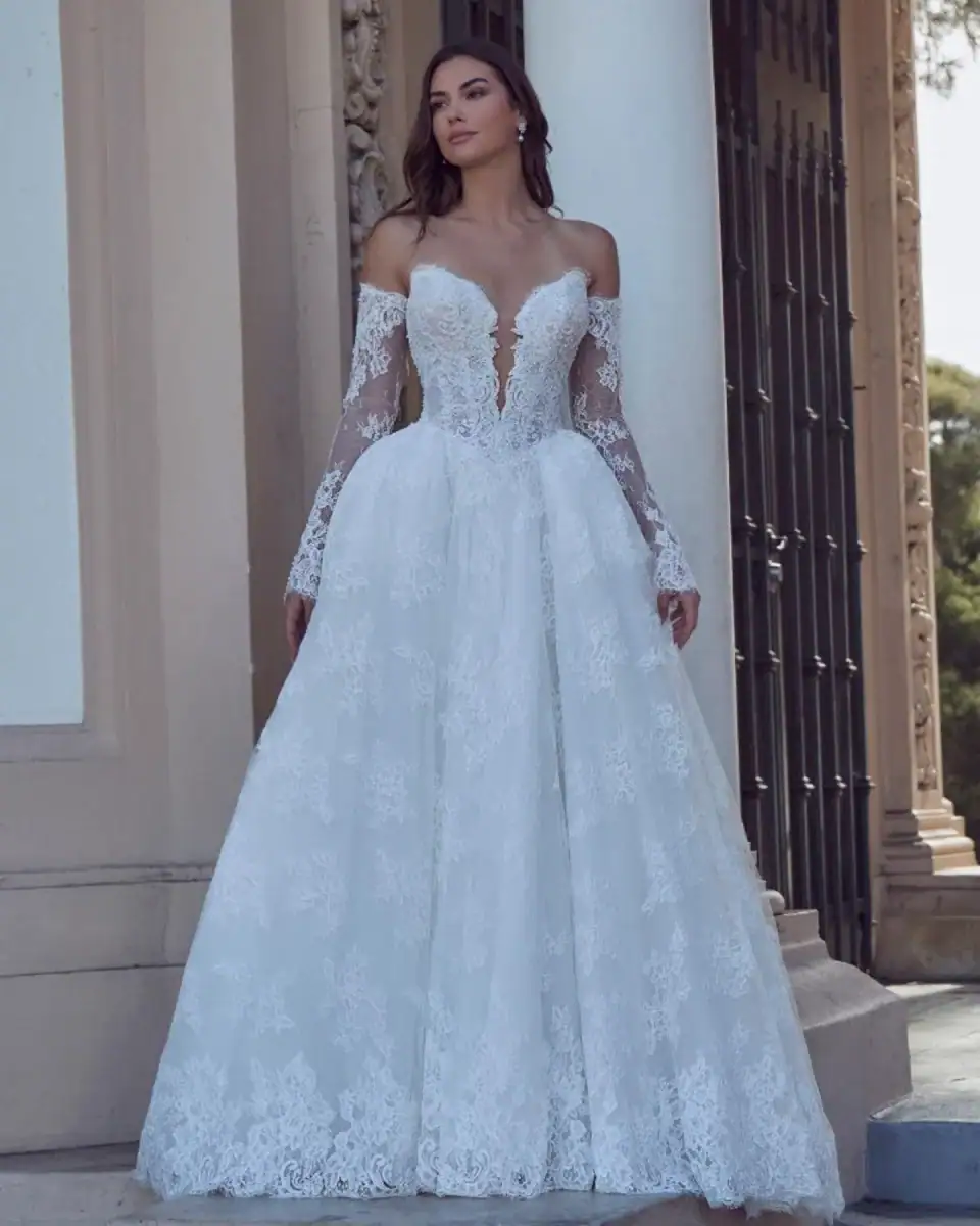 full front of calla blanche persia ivory lace ball gown with a basque waist and matching long sleeves