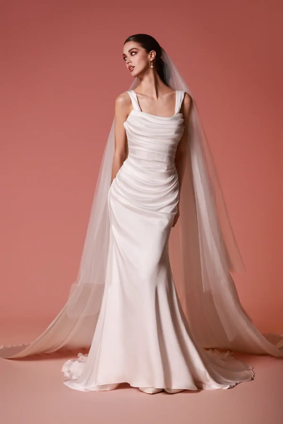 full front of dany tabet lior ivory silky fitted wedding dress with a draped bodice and matching veil