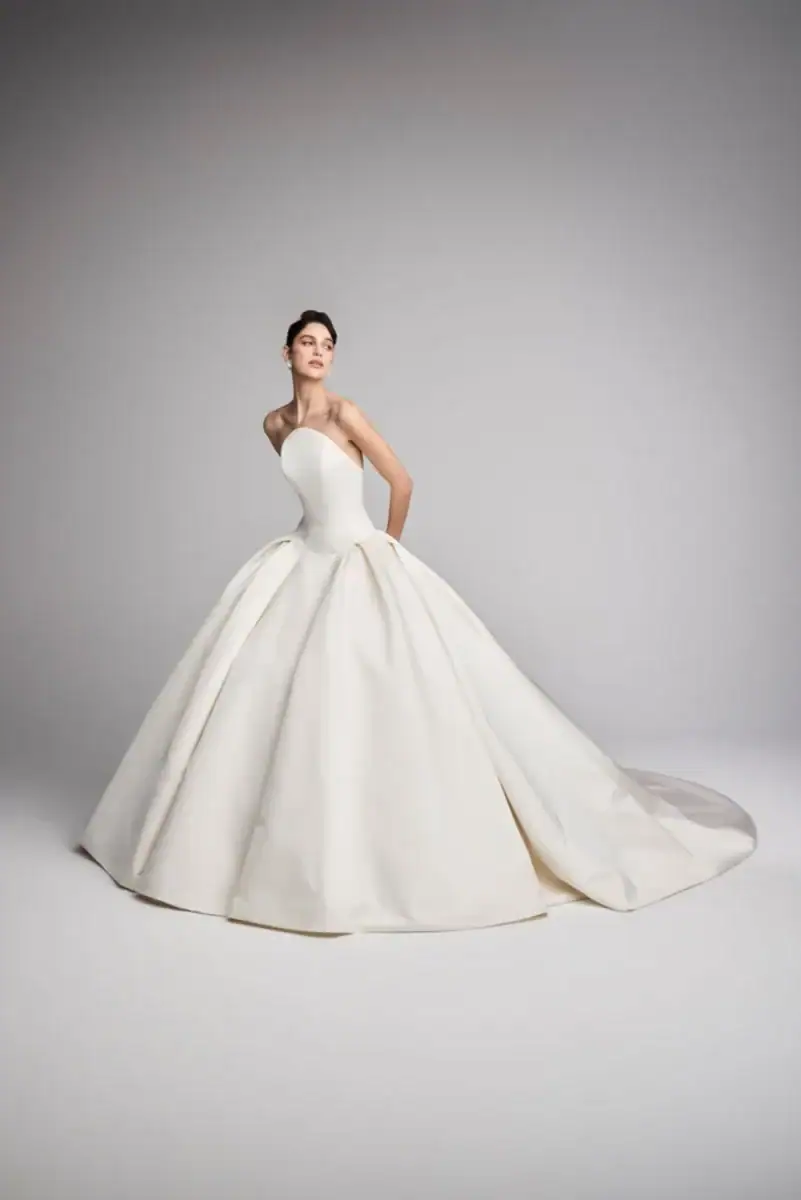 full front of ines di santo dewdrop ivory ball gown wedding dress with a drop waist and rounded strapless neckline