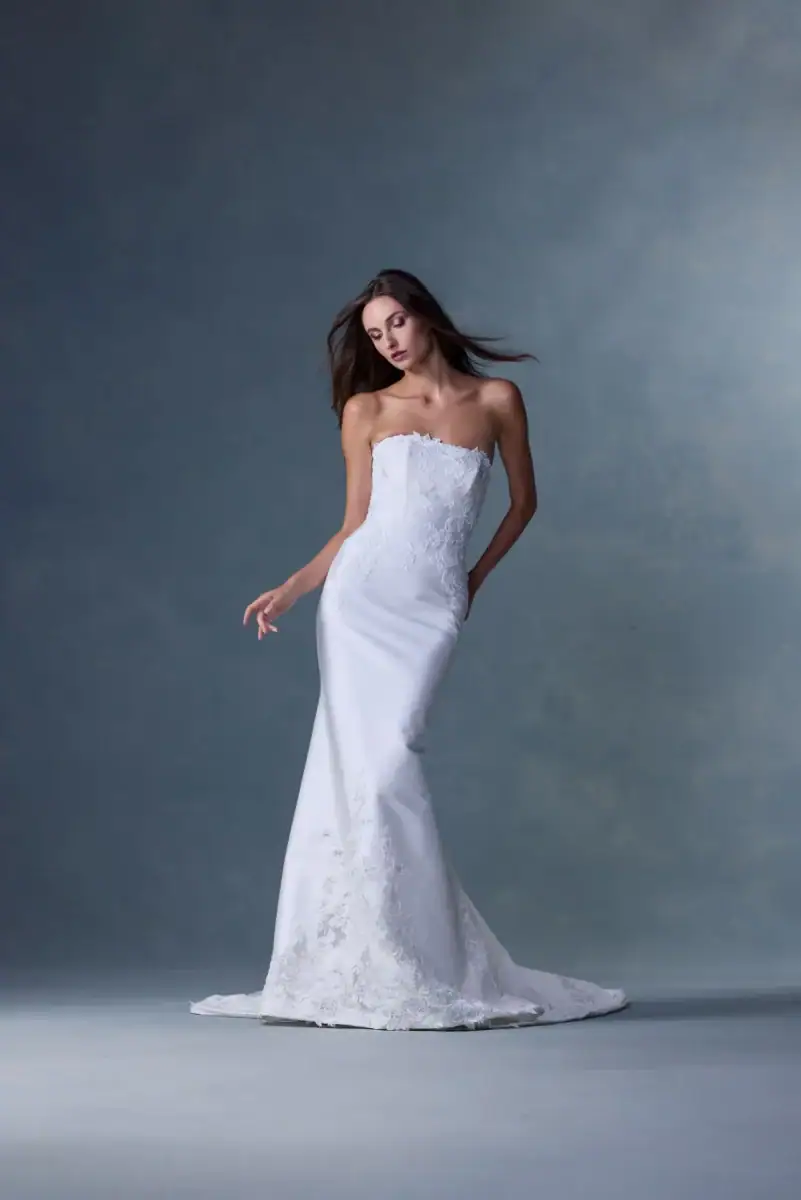 silk fitted wedding dress with lace accents on bodice + hem of skirt
