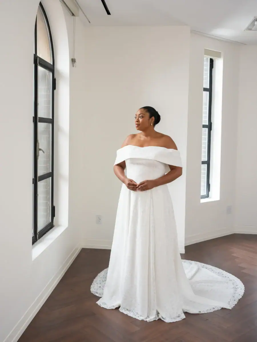 full front of kelly faetanini alethia ivory a-line wedding dress with an off the shoulder neckline