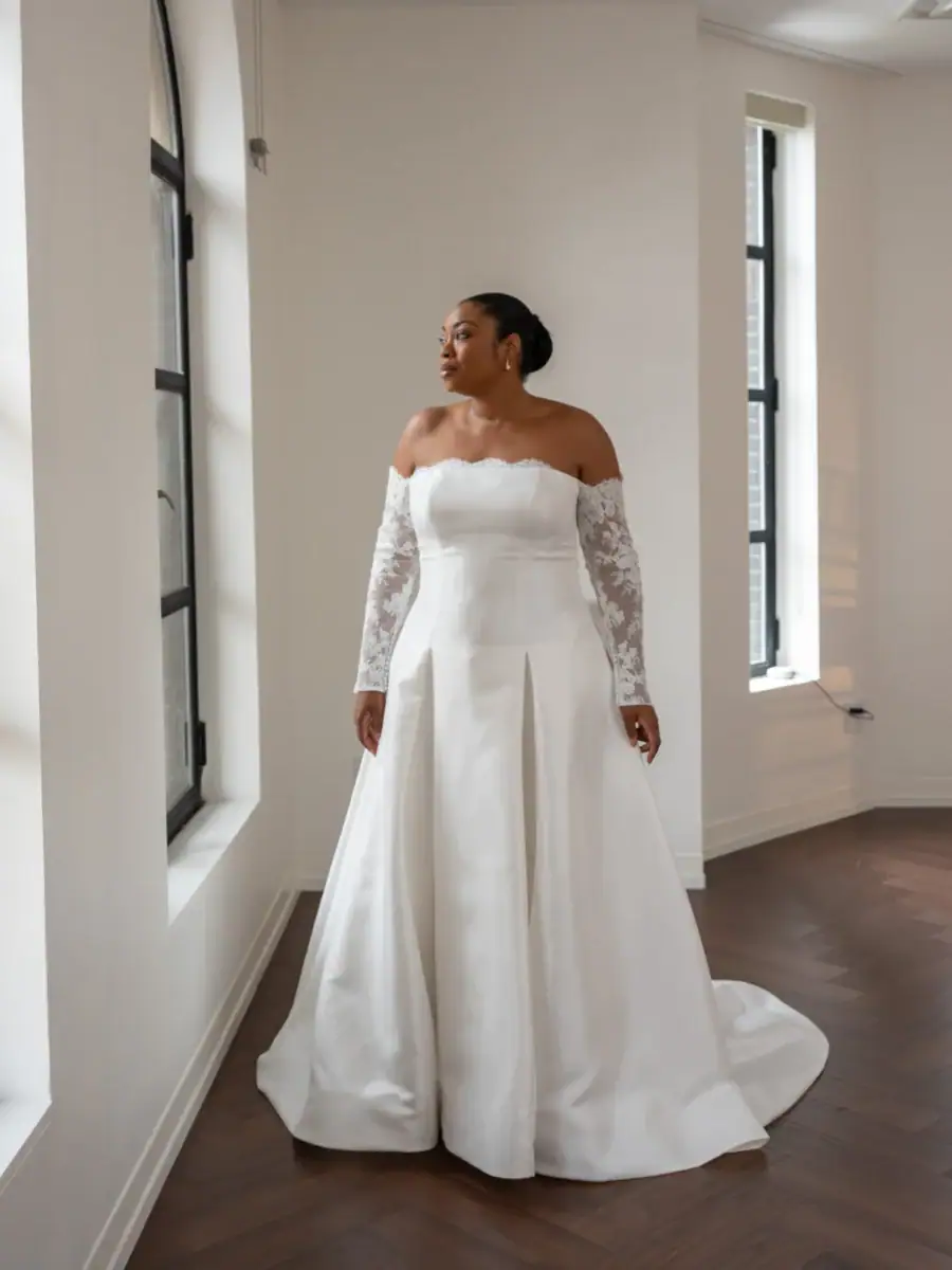 full front of kelly faetanini medea ivory drop waist wedding dress with a strapless bodice and matching long lace sleeves