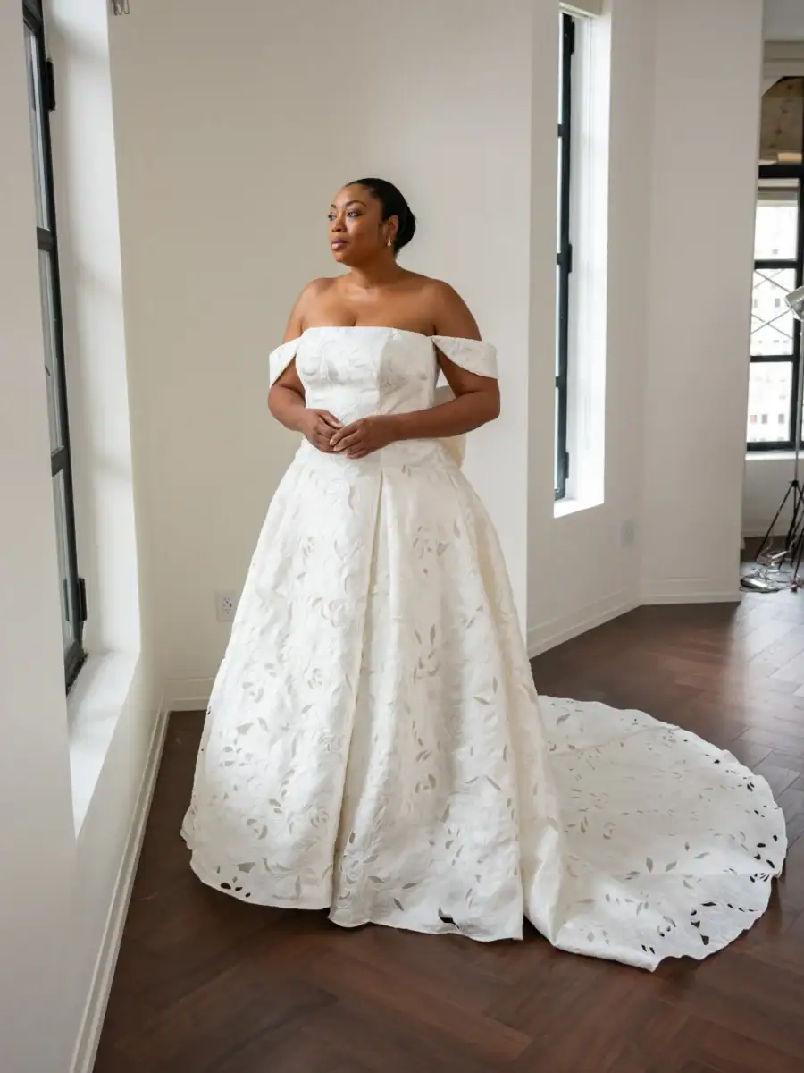 full front of kelly faetanini regalia ivory a-line wedding dress with an off the shoulder neckline