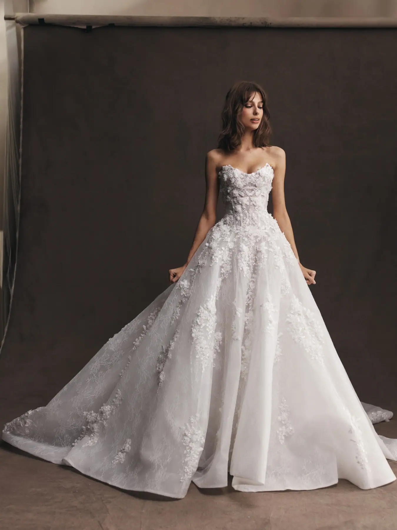 leah da gloria astrid tulle ball gown wedding dress with dimensional floral lace embellishments and strapless bodice