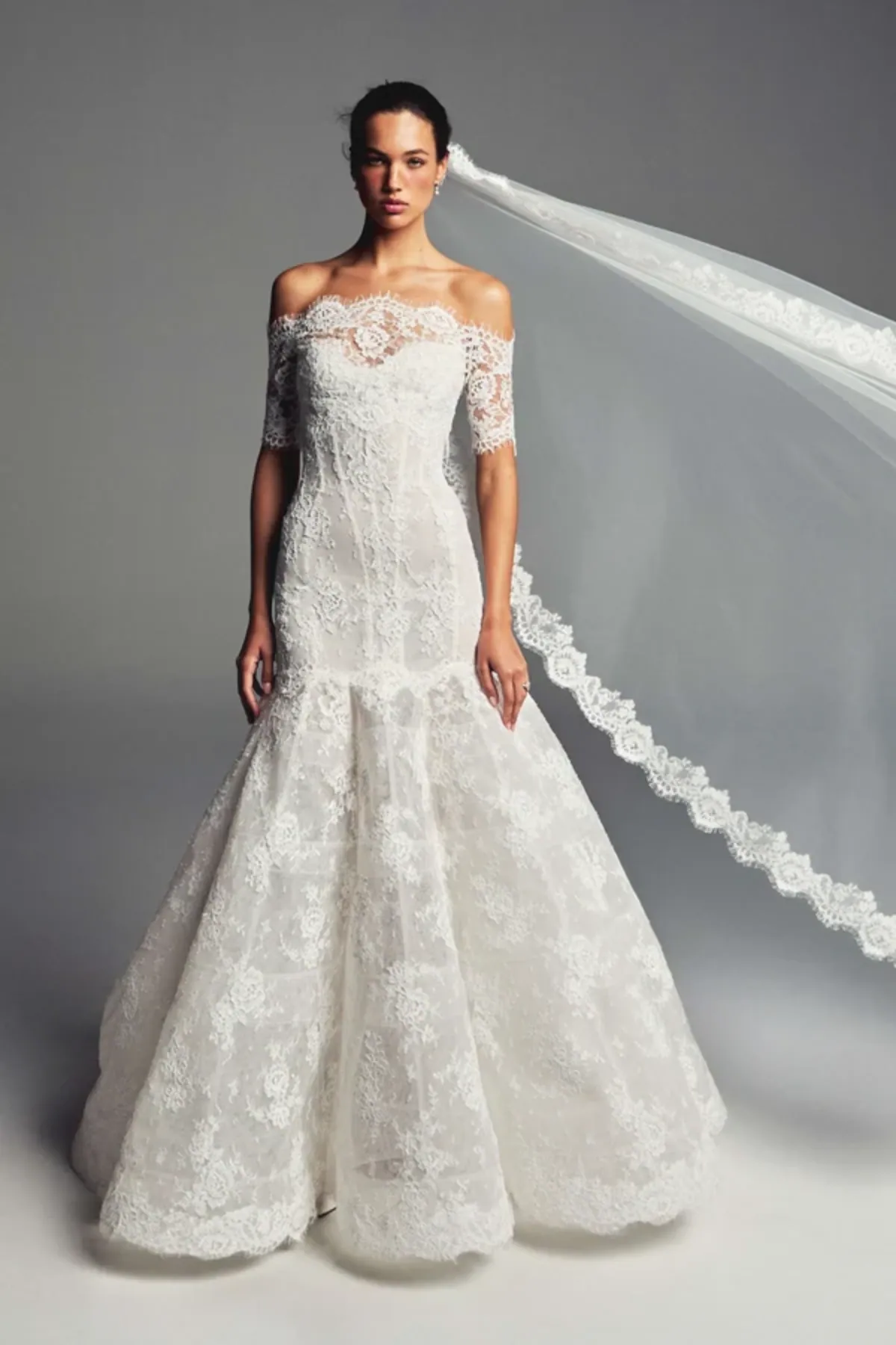 full front of monique lhuillier cherish ivory lace fit and flare wedding dress with an off the shoulder neckline with 3/4 length sleeves