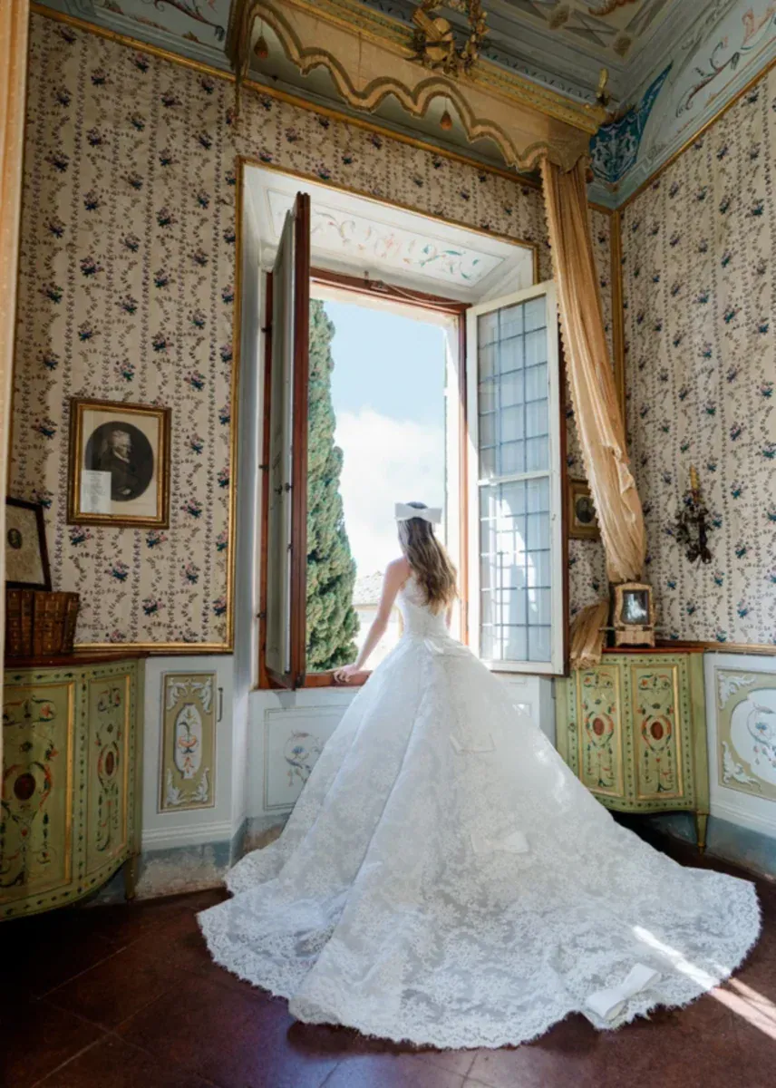 full back of monique lhuillier vittoria detailed lace ball gown wedding dress with a bow