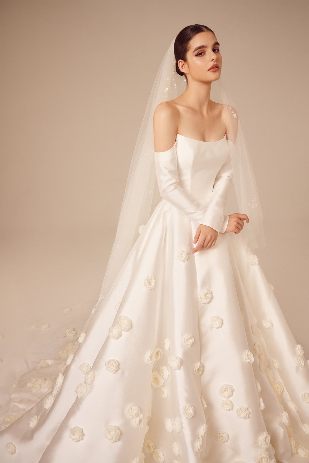 Nicole + Felicia NF035 off-the-shoulder long sleeve wedding dress with floral details on skirt