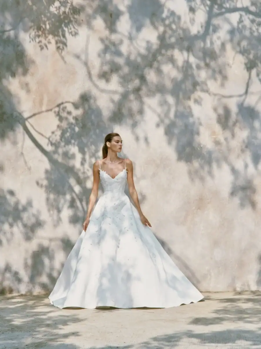 full front of nicole + felicia nf153 ball gown wedding dress with a v neckline and thin straps