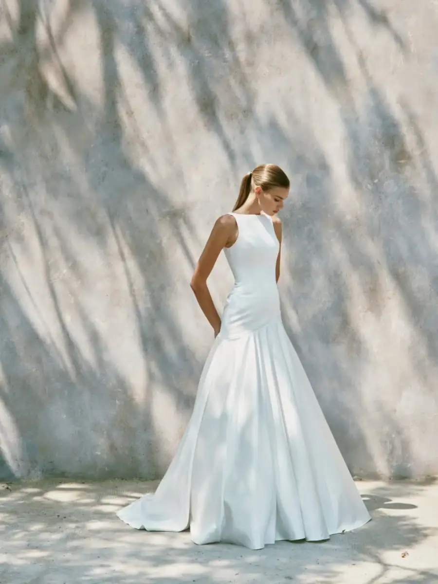 full front of nicole + felicia nf164 ivory satin fit and flare wedding dress with a high neckline and flared skirt