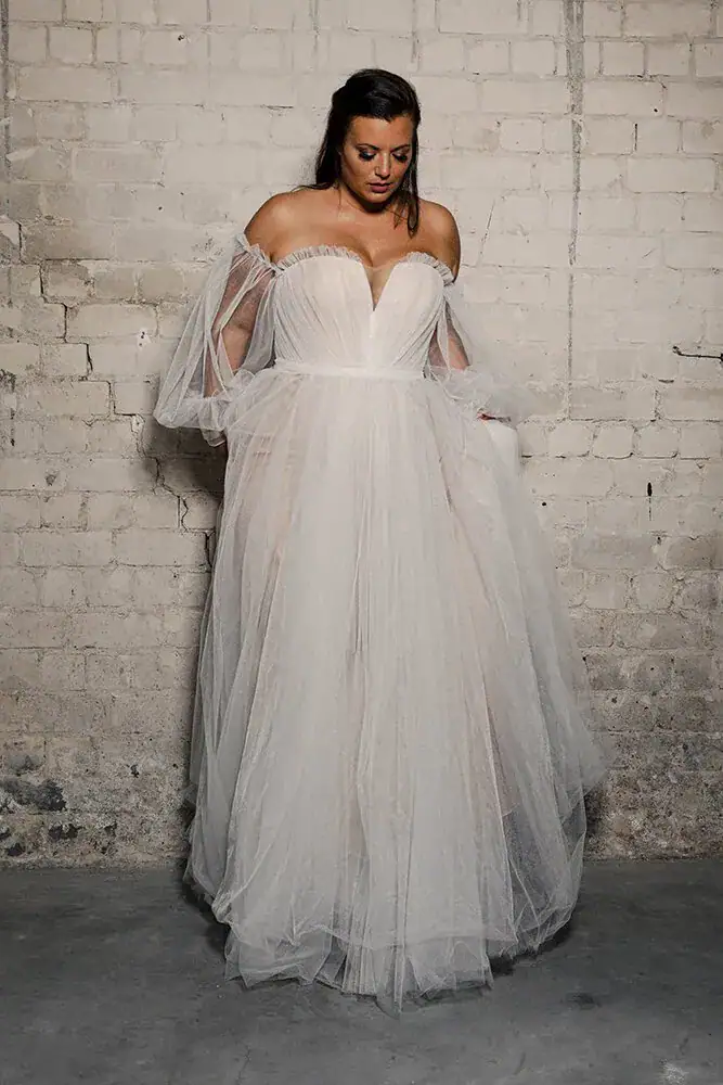 Model wearing plus size wedding gown Studio Levana Tamia