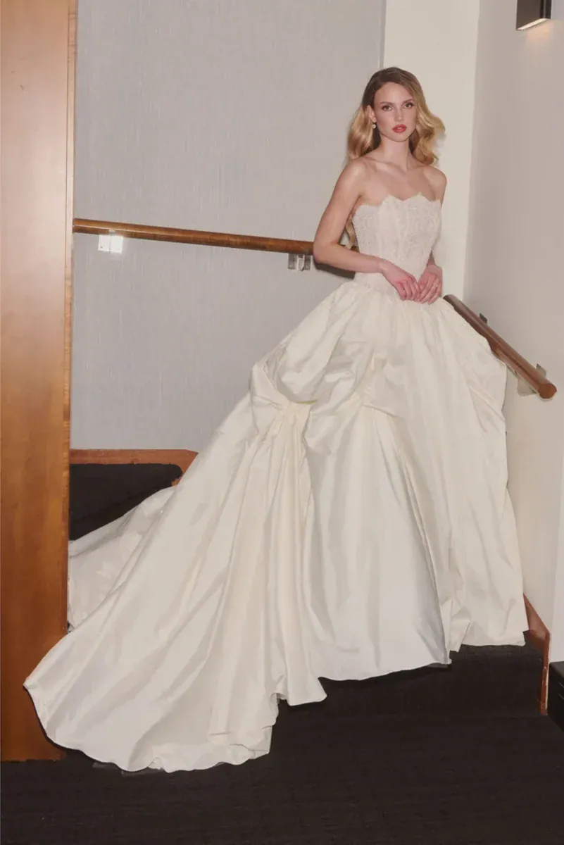 full front of veronica di santo the ceremony ivory silky ball gown with a dramatic skirt and scalloped neckline