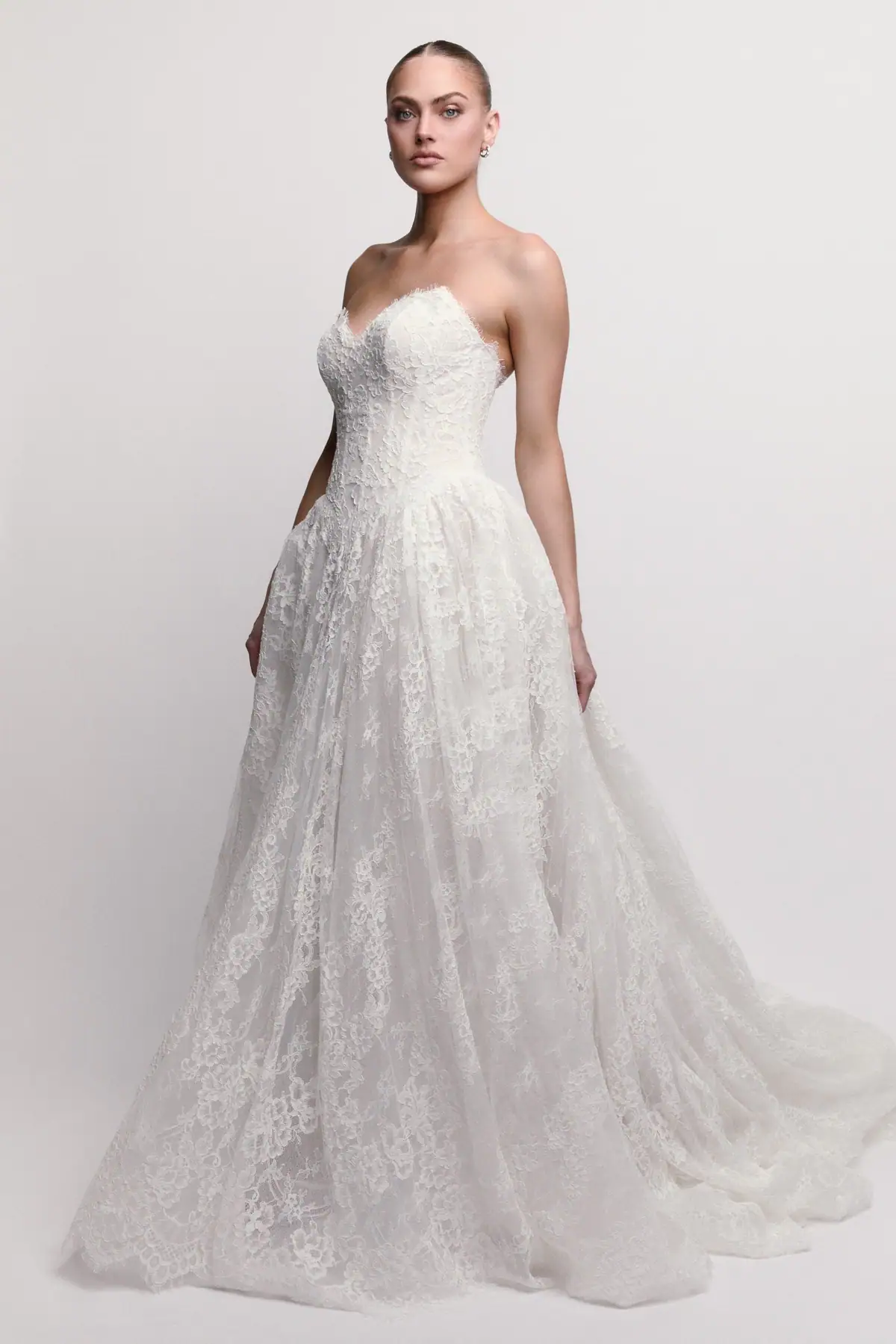 Lace ball gown wedding dress with basque waist and pointed neckline